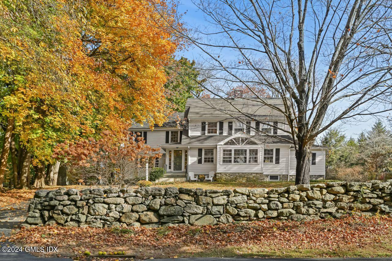 242 Taconic Road Greenwich, CT 06831 - Photo 2 of 37 front view of a house with a trees