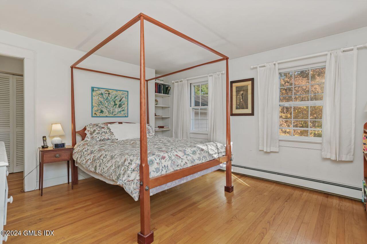 242 Taconic Road Greenwich, CT 06831 - Photo 23 of 37 a bedroom with a bed and wooden floor