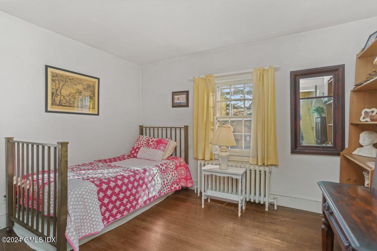 242 Taconic Road Greenwich, CT 06831 - Photo 24 of 37 a bedroom with a bed and a window