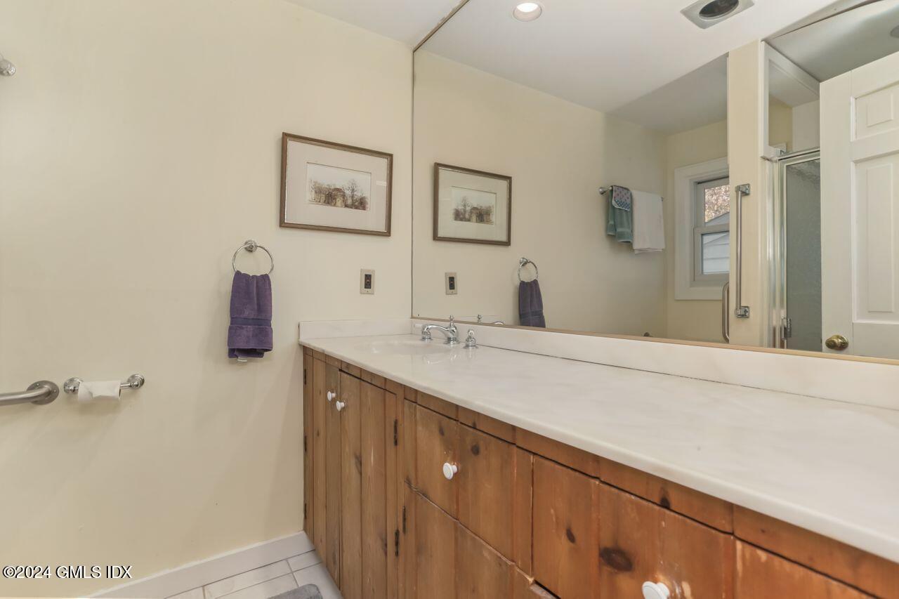 242 Taconic Road Greenwich, CT 06831 - Photo 28 of 37 a bathroom with a double vanity sink and mirror