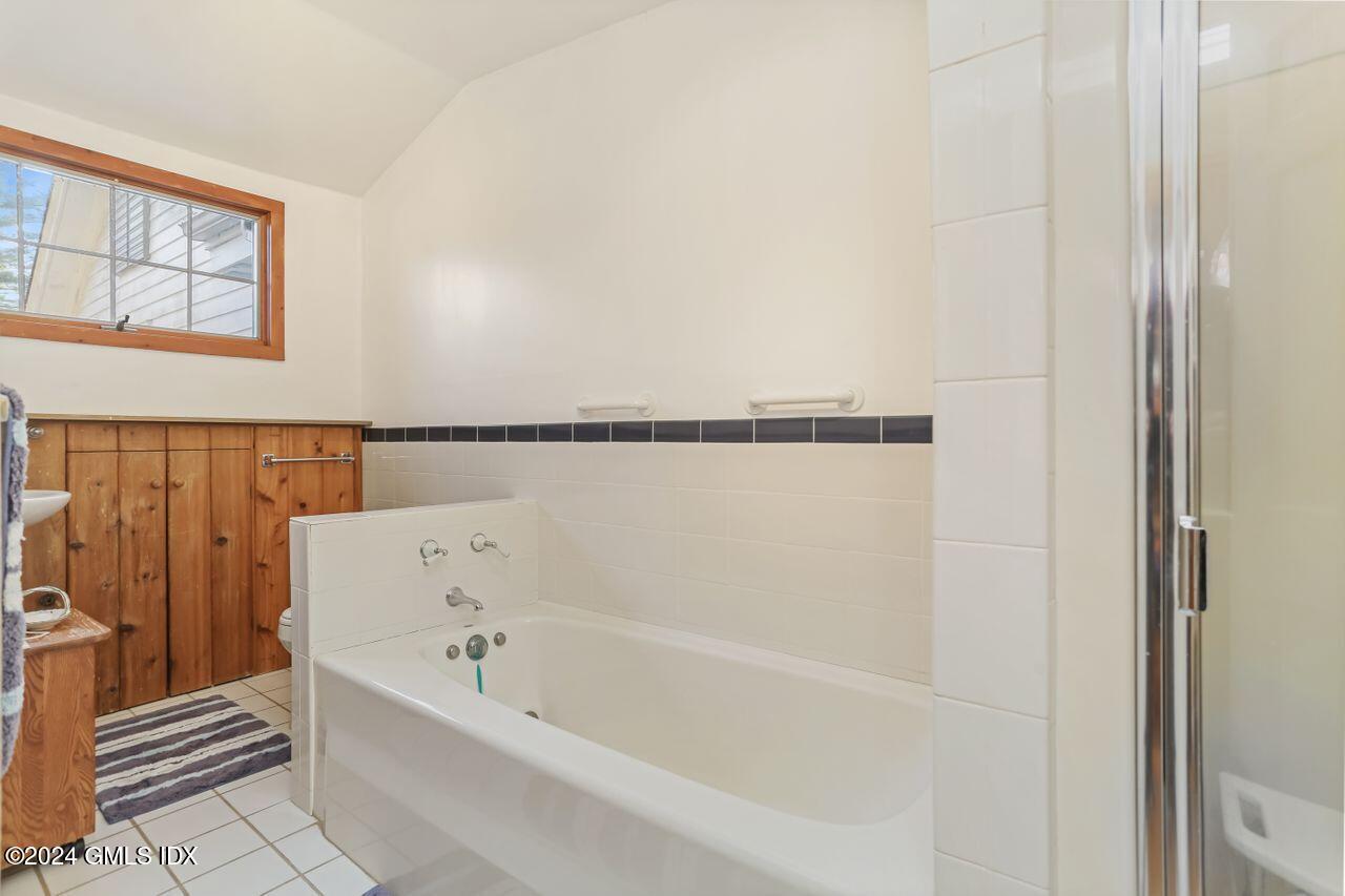 242 Taconic Road Greenwich, CT 06831 - Photo 29 of 37 a bathroom with bathtub and shower