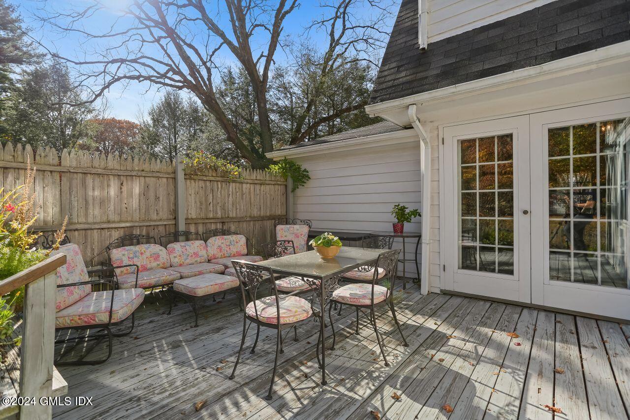 242 Taconic Road Greenwich, CT 06831 - Photo 30 of 37 a backyard of a house with dining table and chairs