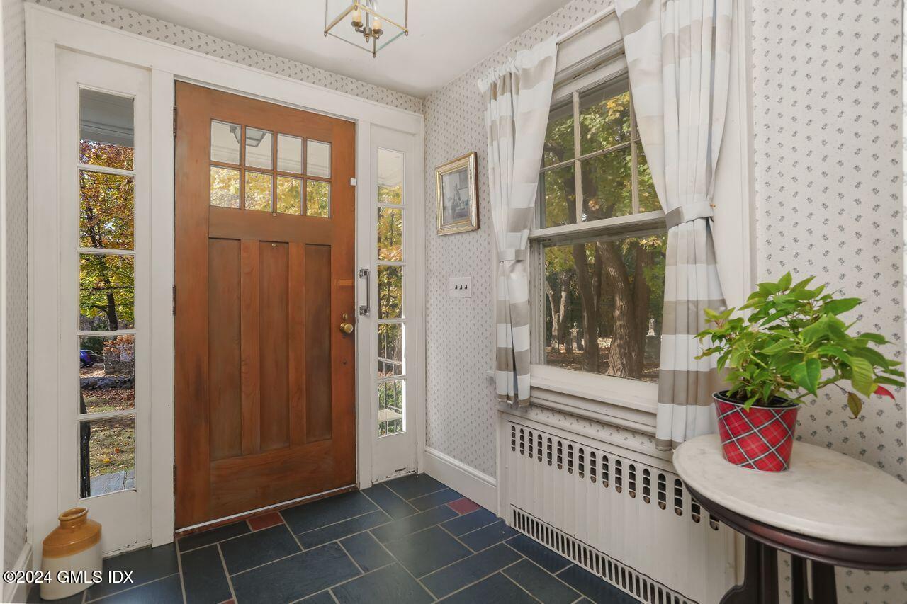 242 Taconic Road Greenwich, CT 06831 - Photo 3 of 37 a view of front door and porch with wooden floor