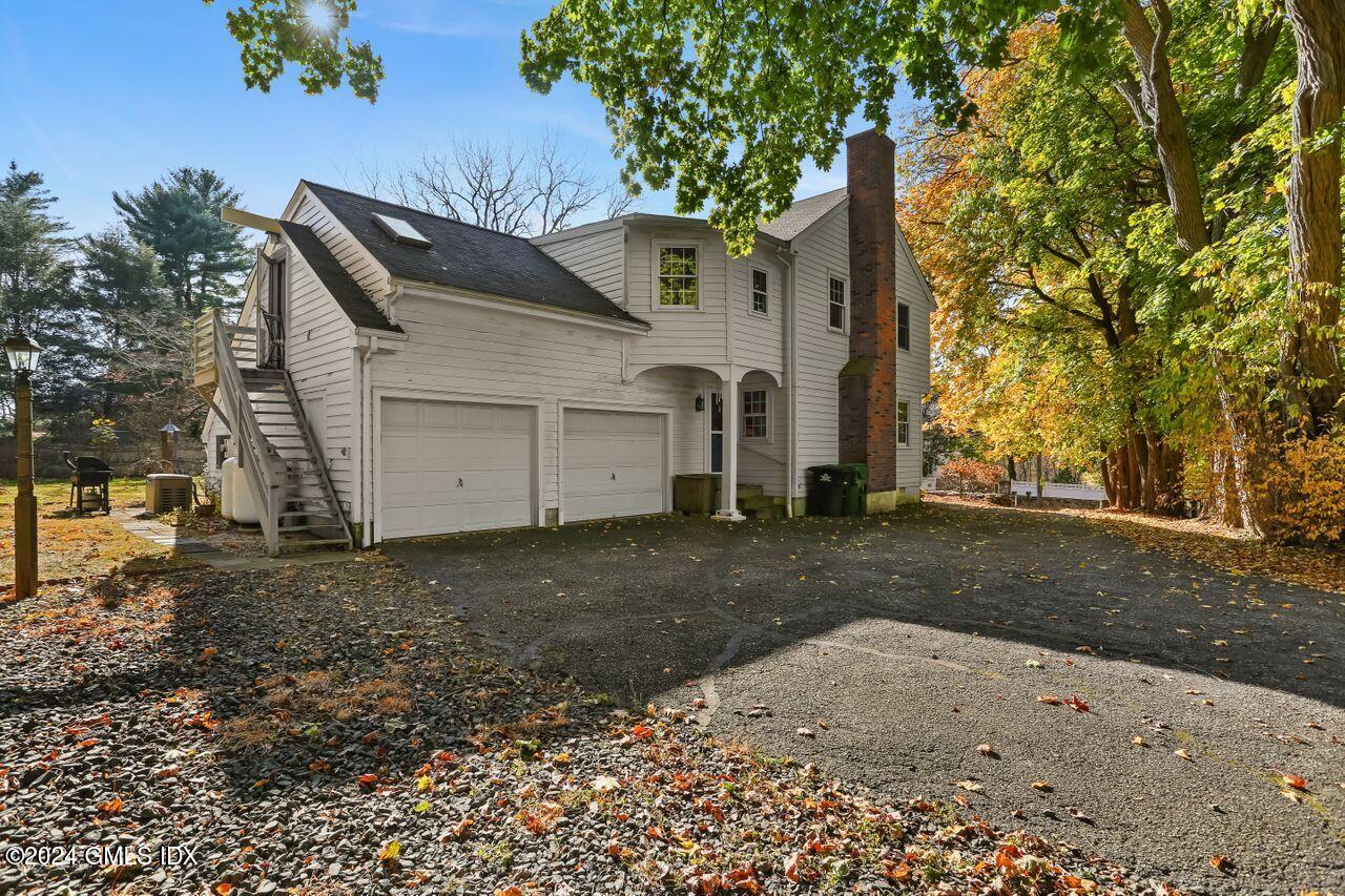 242 Taconic Road Greenwich, CT 06831 - Photo 32 of 37 a view of a house with a yard