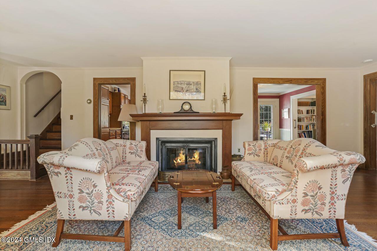 242 Taconic Road Greenwich, CT 06831 - Photo 5 of 37 a living room with furniture a fireplace and a large mirror
