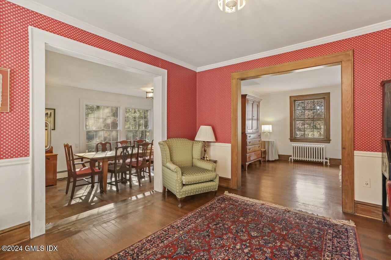 242 Taconic Road Greenwich, CT 06831 - Photo 10 of 37 a living room with furniture and a large mirror next to a window