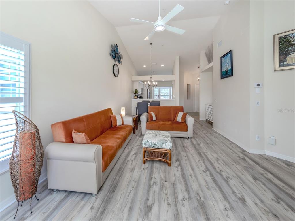 901 Addington Court, Unit 203 Venice, FL 34293 - Photo 19 of 61 a living room with furniture and a wooden floor