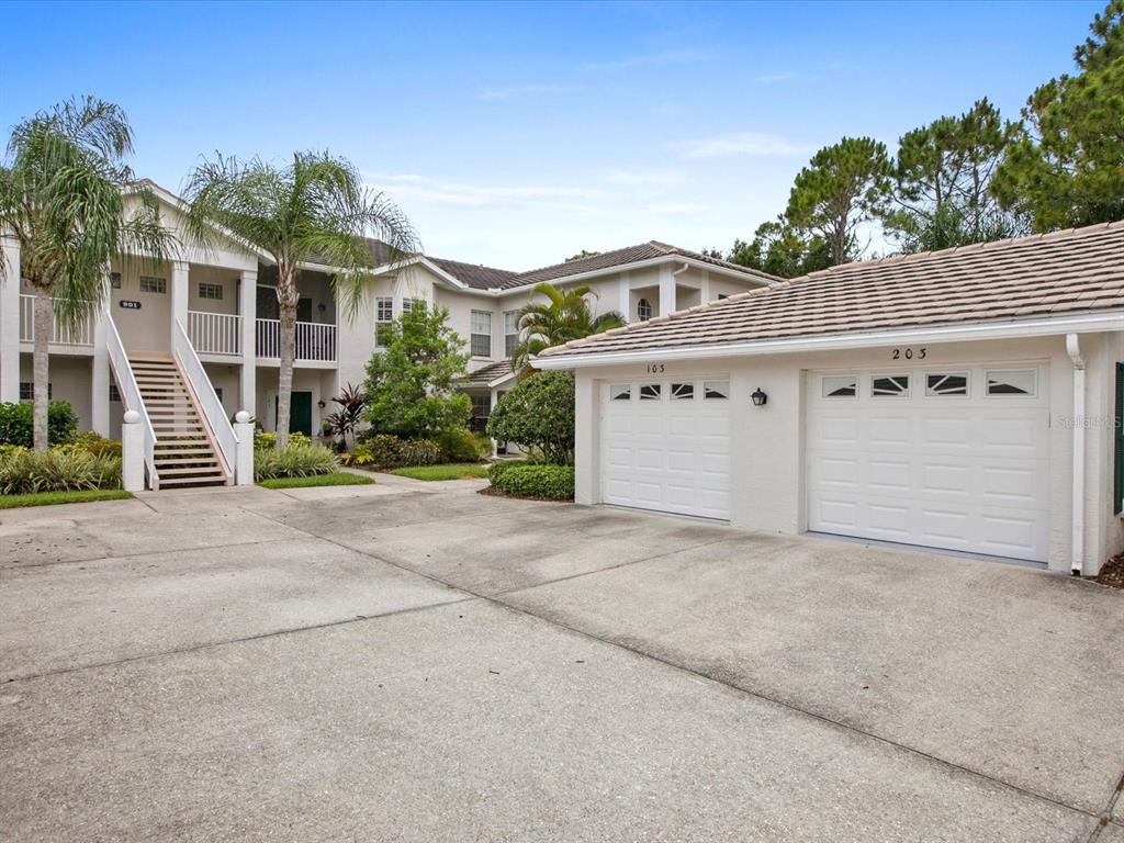 901 Addington Court, Unit 203 Venice, FL 34293 - Photo 2 of 61 front view of a house with a street