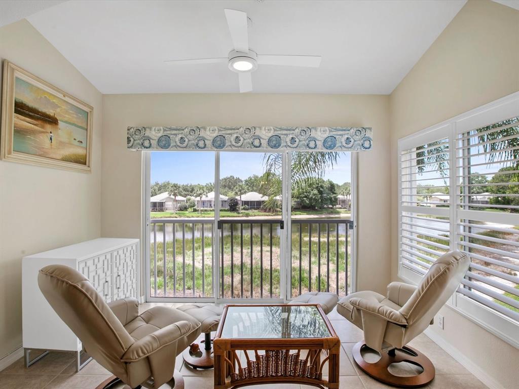 901 Addington Court, Unit 203 Venice, FL 34293 - Photo 21 of 61 a living room with furniture and floor to ceiling windows