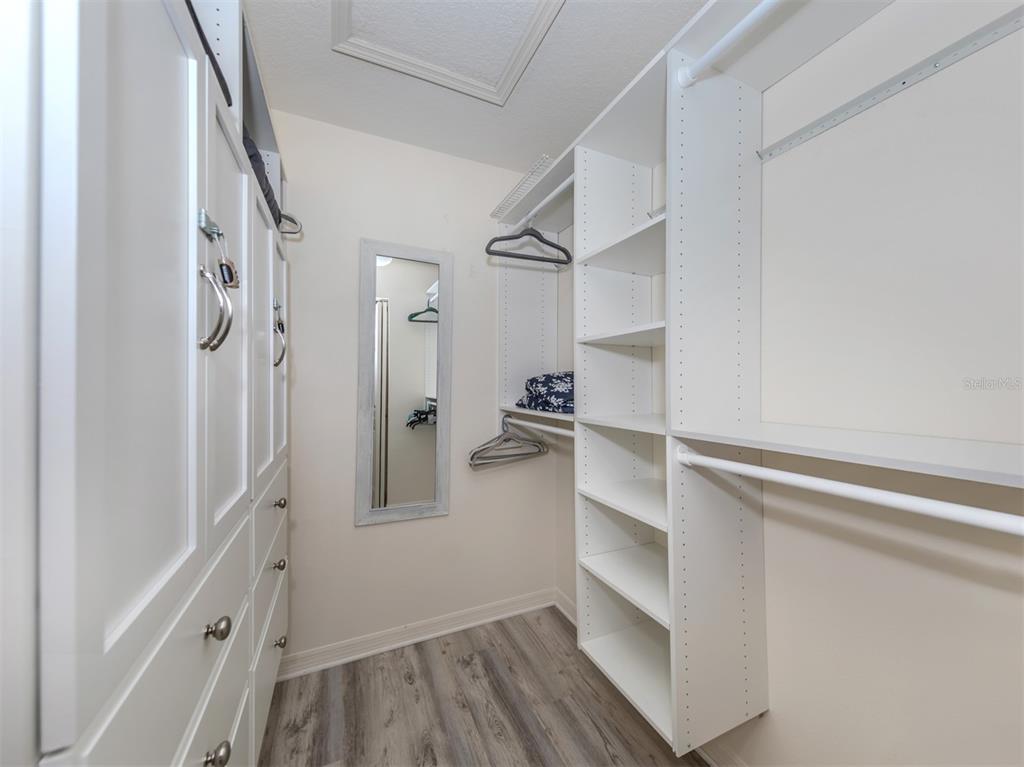 901 Addington Court, Unit 203 Venice, FL 34293 - Photo 26 of 61 a view of walk in closet with empty racks