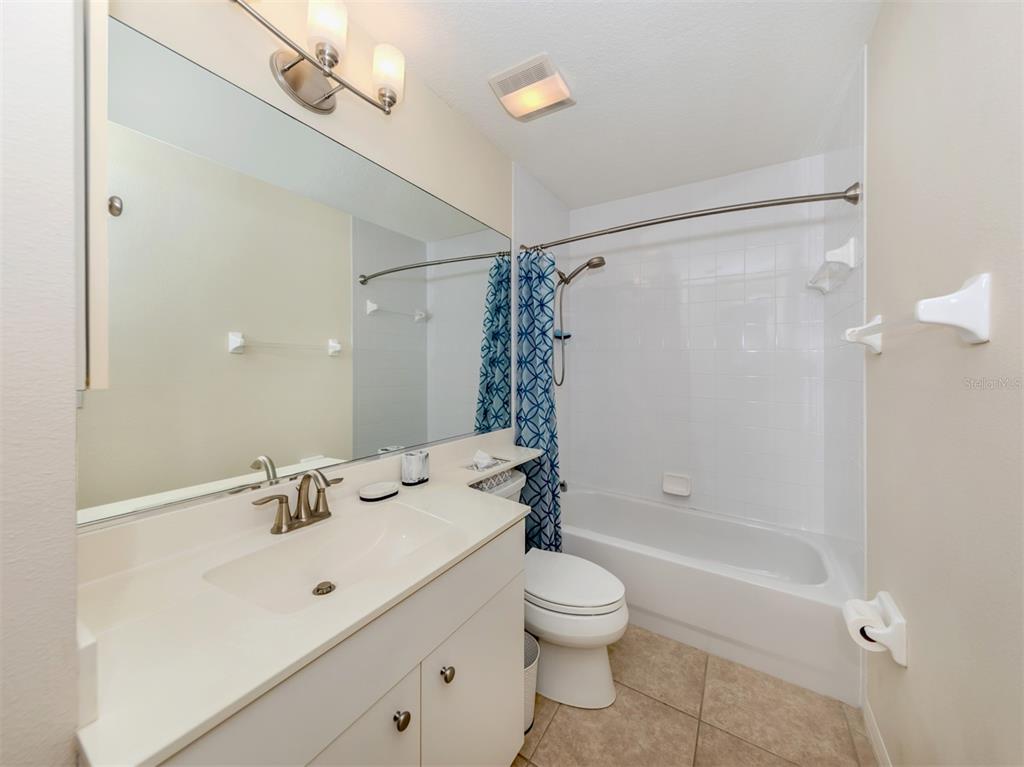 901 Addington Court, Unit 203 Venice, FL 34293 - Photo 28 of 61 a bathroom with a sink a toilet and shower