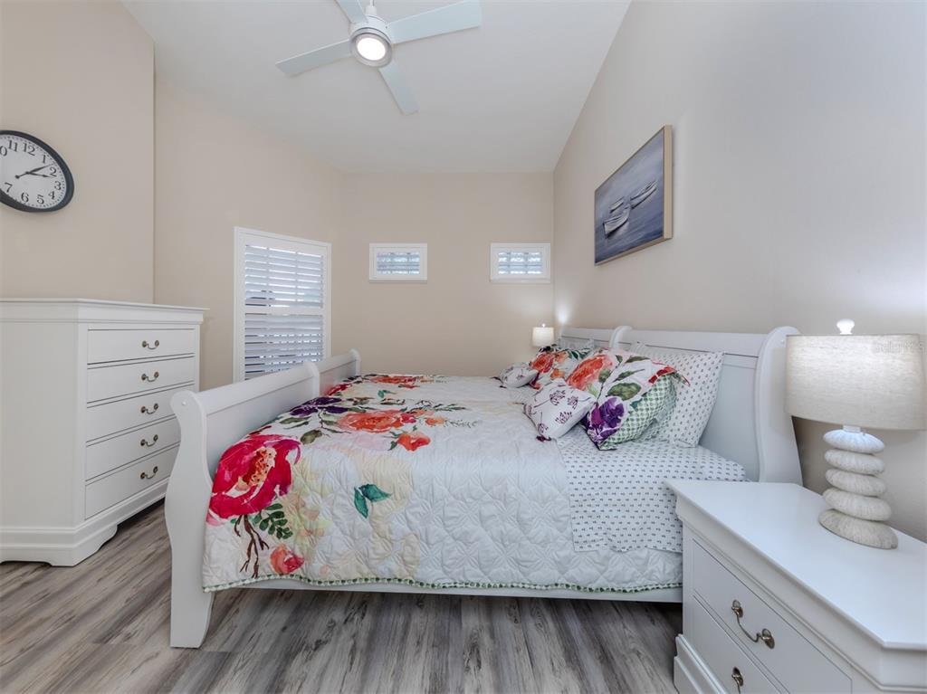 901 Addington Court, Unit 203 Venice, FL 34293 - Photo 29 of 61 a bedroom with a bed and a dresser