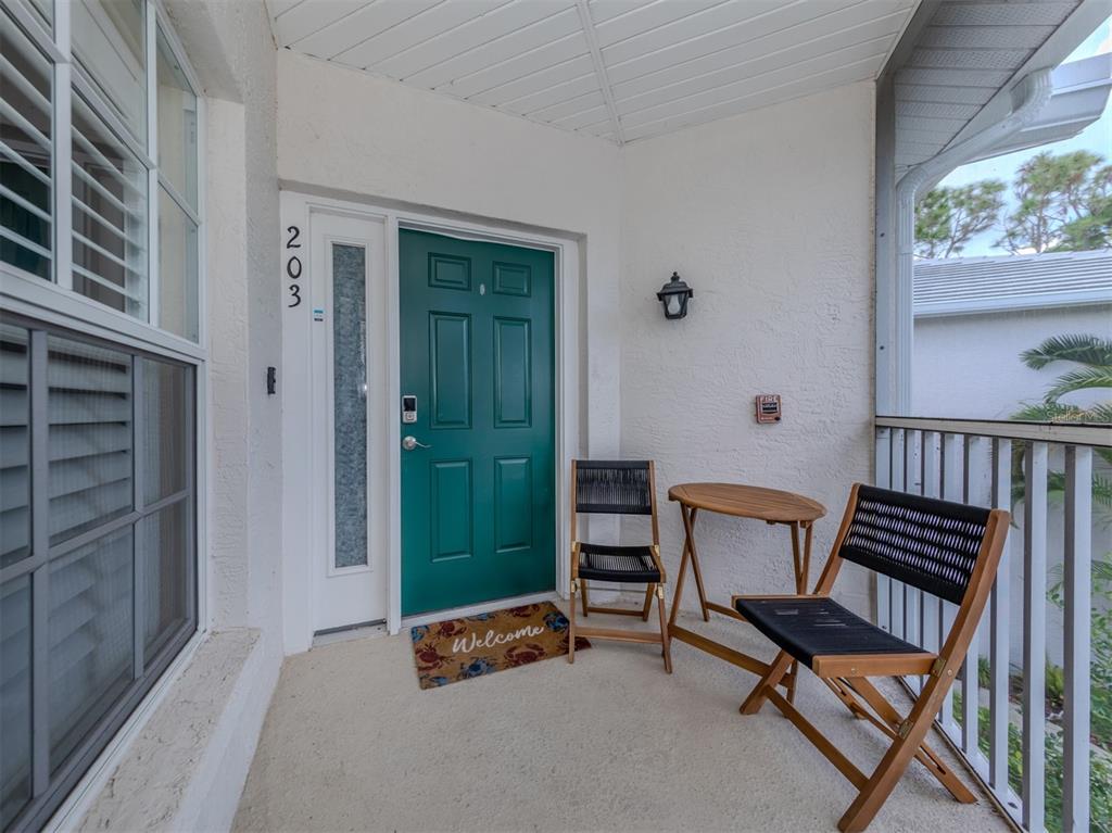 901 Addington Court, Unit 203 Venice, FL 34293 - Photo 3 of 61 a room with furniture and a window