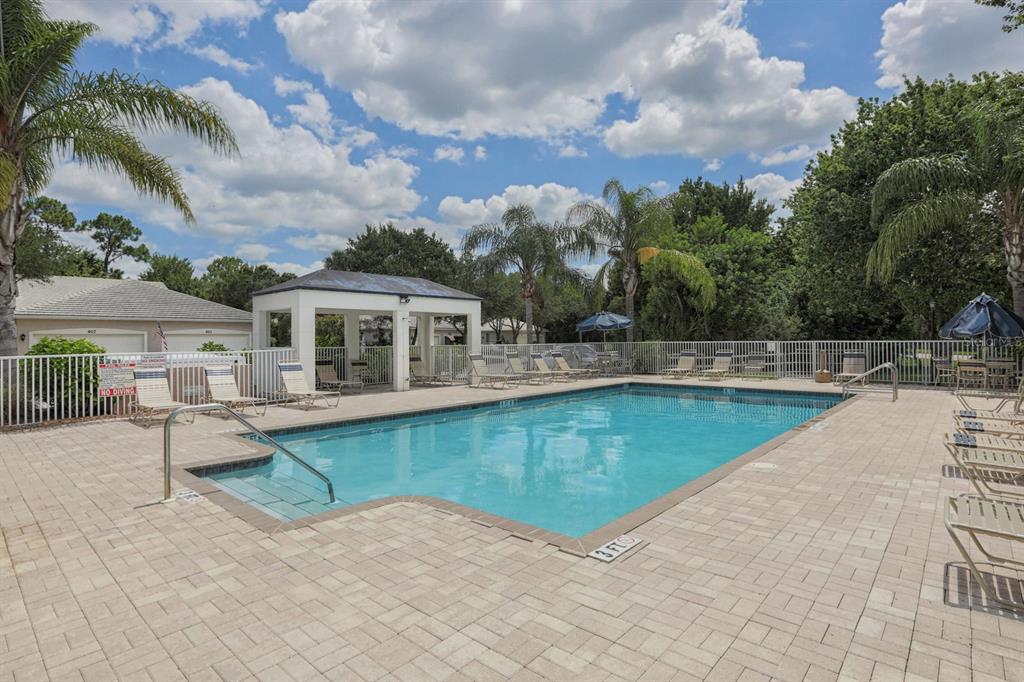 901 Addington Court, Unit 203 Venice, FL 34293 - Photo 38 of 61 a view of a house with pool and chairs