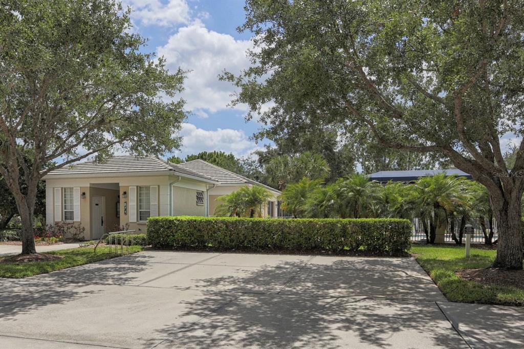 901 Addington Court, Unit 203 Venice, FL 34293 - Photo 40 of 61 a front view of a house with a garden
