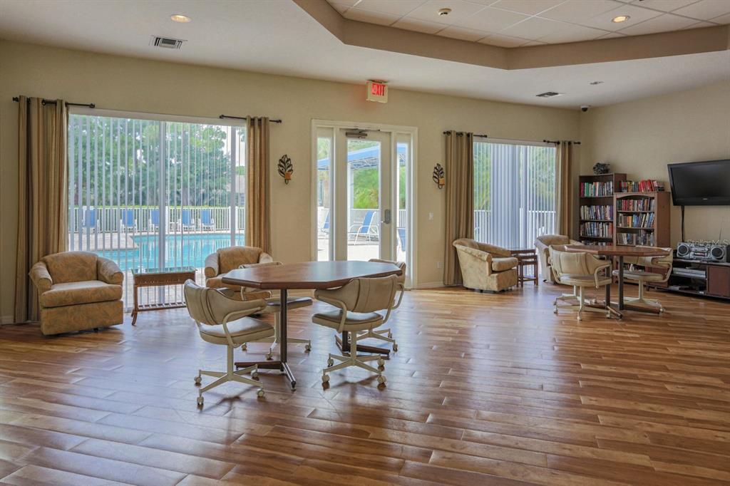 901 Addington Court, Unit 203 Venice, FL 34293 - Photo 42 of 61 a living room with furniture and a large window