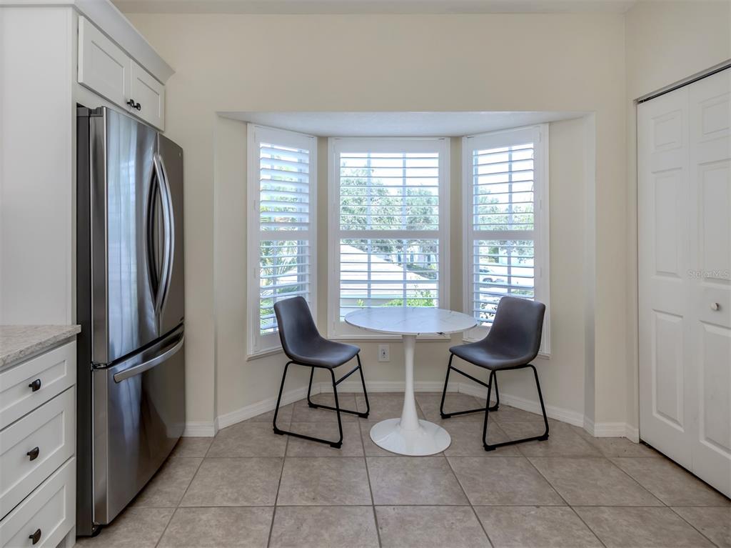 901 Addington Court, Unit 203 Venice, FL 34293 - Photo 9 of 61 a view of dining room and chairs in a room