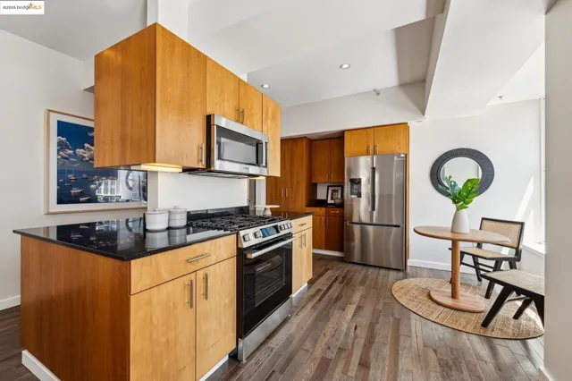 a living room with stainless steel appliances kitchen island granite countertop furniture and a kitchen view