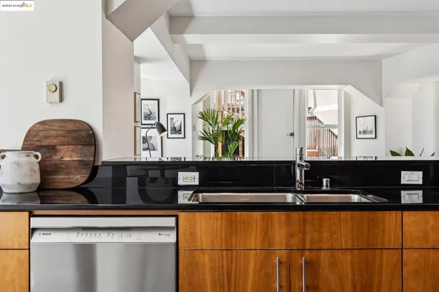 a kitchen with a refrigerator a table and chairs