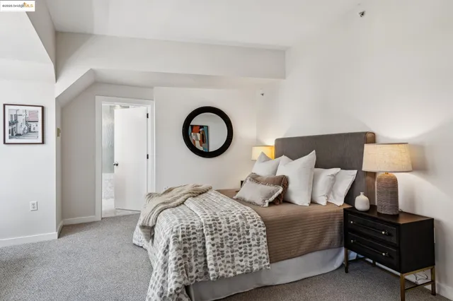 a bedroom with a bed and a night stand