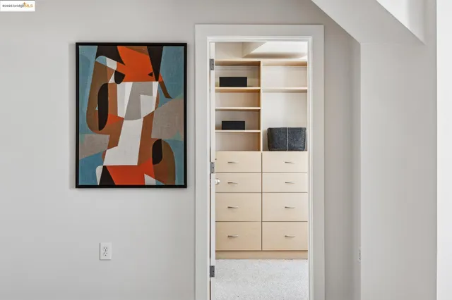 a kitchen with white cabinets and window