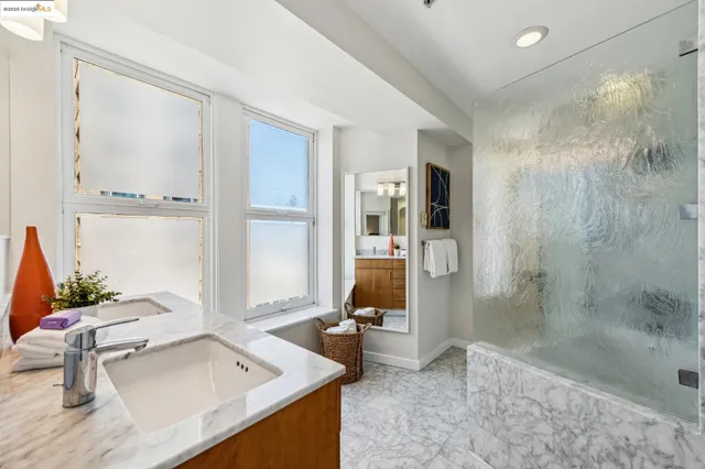 a bed sitting in a bedroom next to a lamp