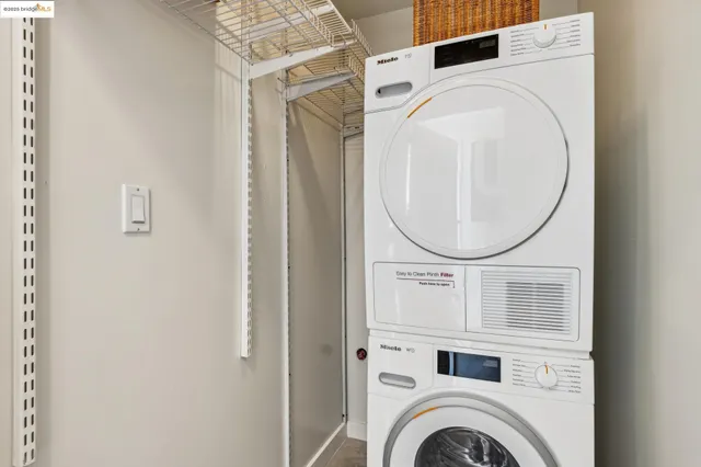 a living room with furniture a chandelier and a floor to ceiling window