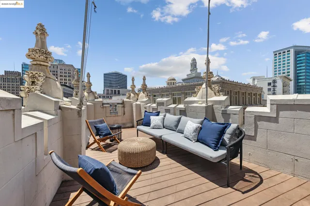 a living room with furniture a chandelier and a rug