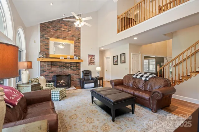 a living room with furniture a fireplace and a large window