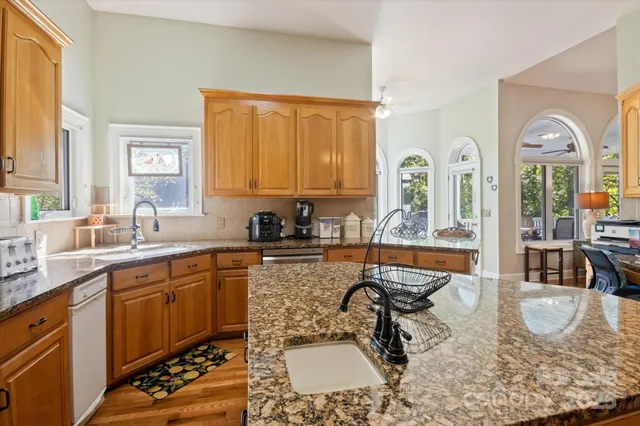a large kitchen with a lot of counter space and windows