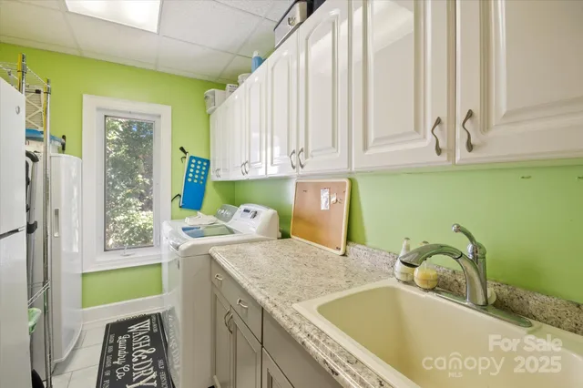 a bathroom with a granite countertop sink and a bathtub