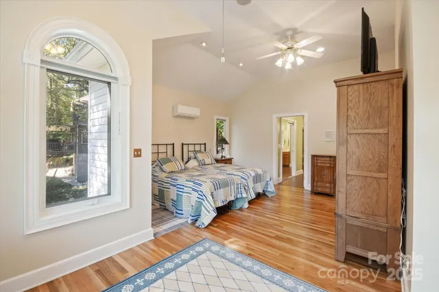 a bedroom with a bed lamps and a large mirror on the dresser