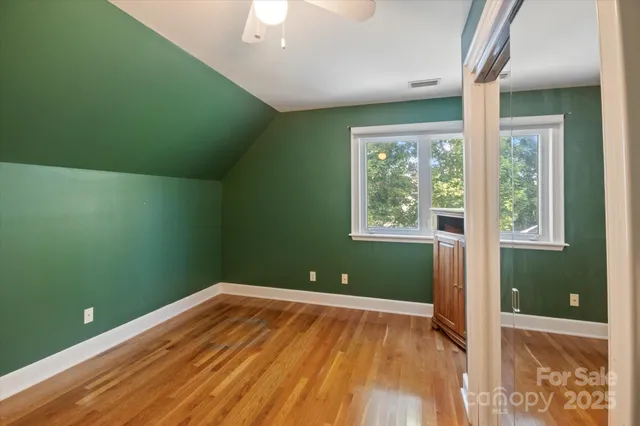 a view of a room with wooden floor and windows