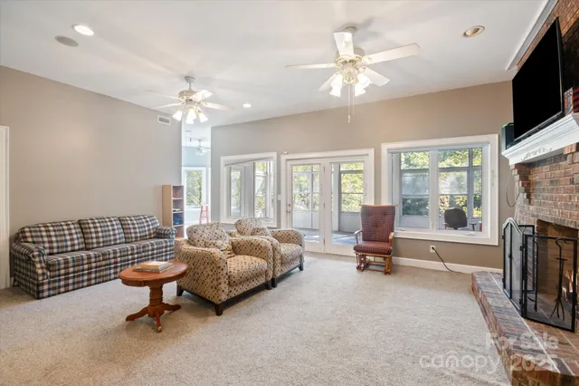 a living room with furniture fireplace and flat screen tv