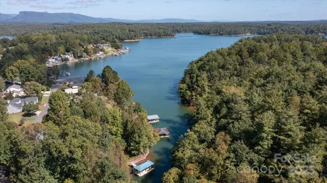 an aerial view of a houses with a lake view