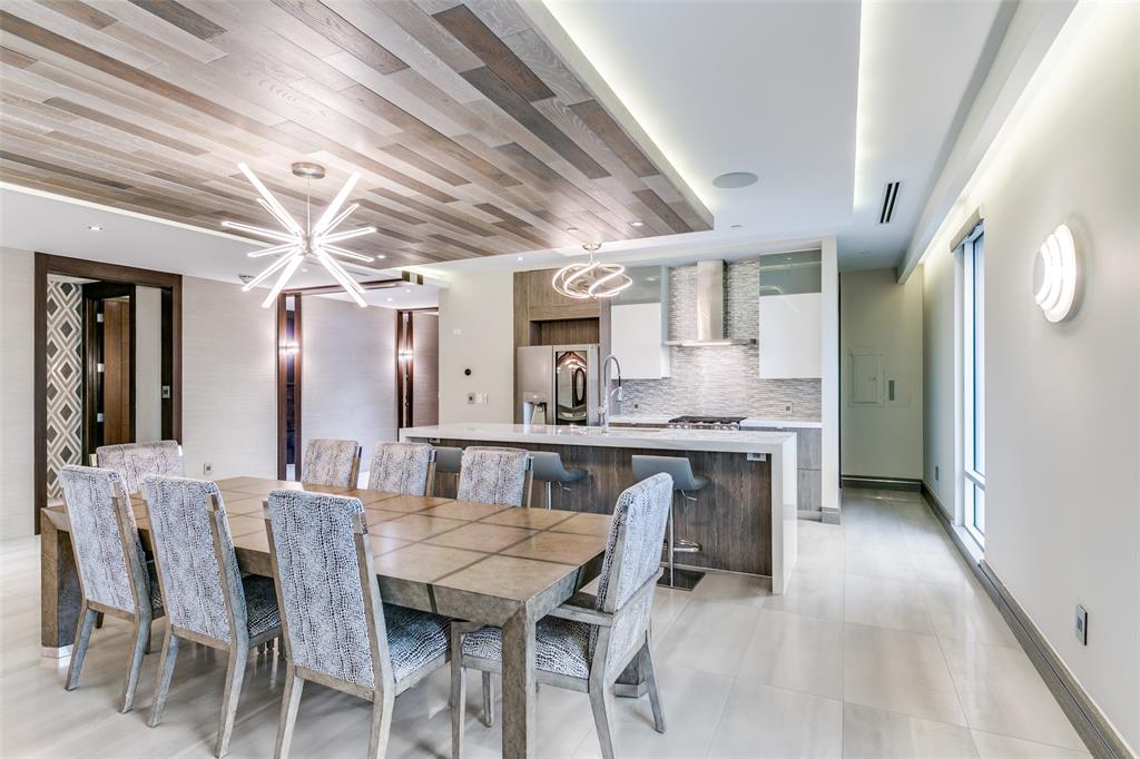 4005 Gaston Avenue, Unit PH2 Dallas, TX 75246 - Photo 11 of 33 Dining room featuring a chandelier and light tile patterned floors