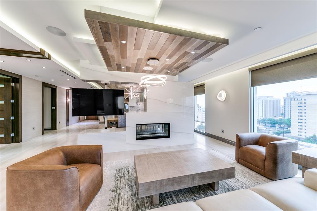 4005 Gaston Avenue, Unit PH2 Dallas, TX 75246 - Photo 2 of 33 Living room featuring a large fireplace, recessed lighting, and wooden ceiling