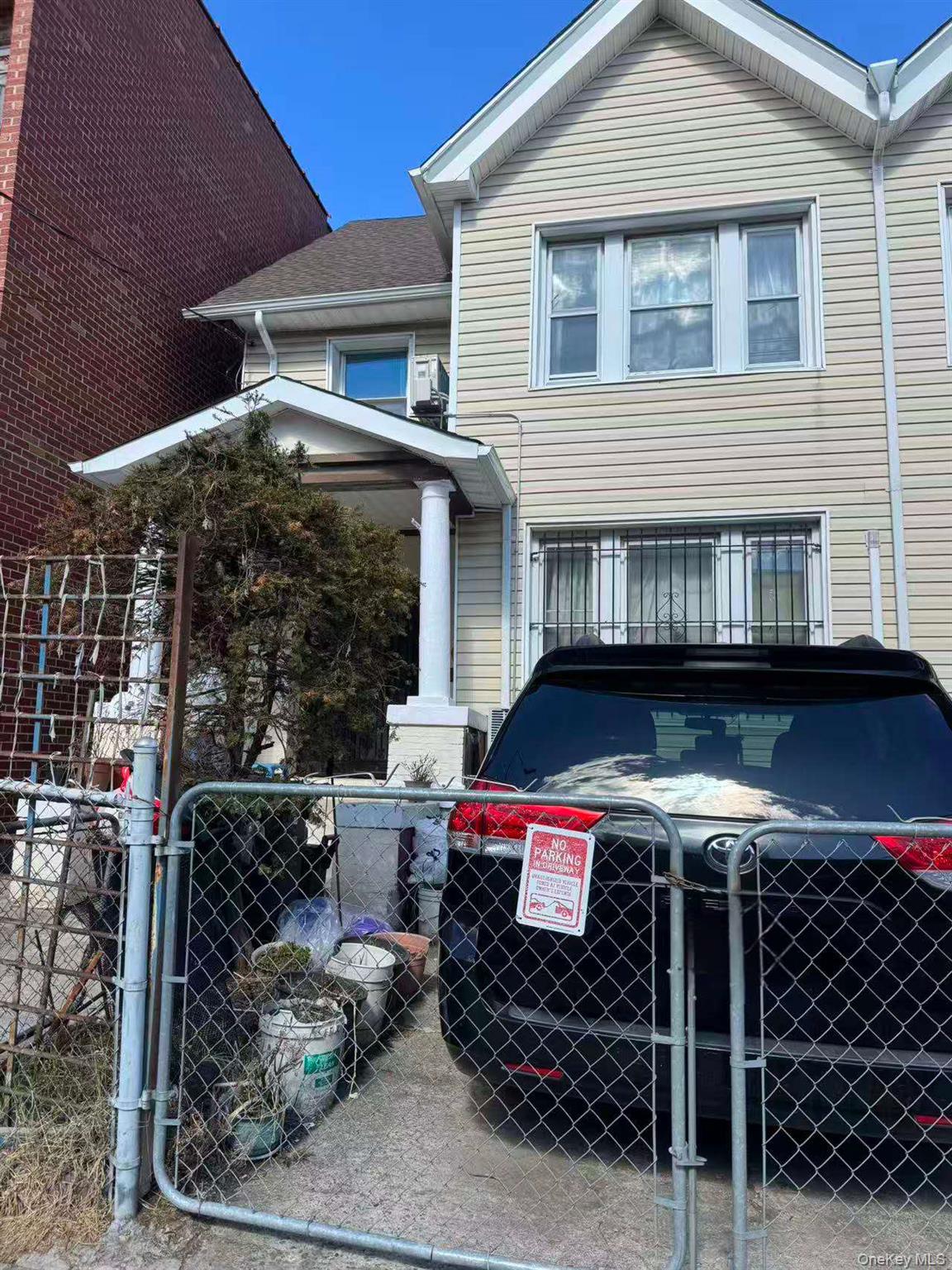 41-31 Hampton Street Queens, NY 11373 - Photo 1 of 23 a front view of a house with parking space