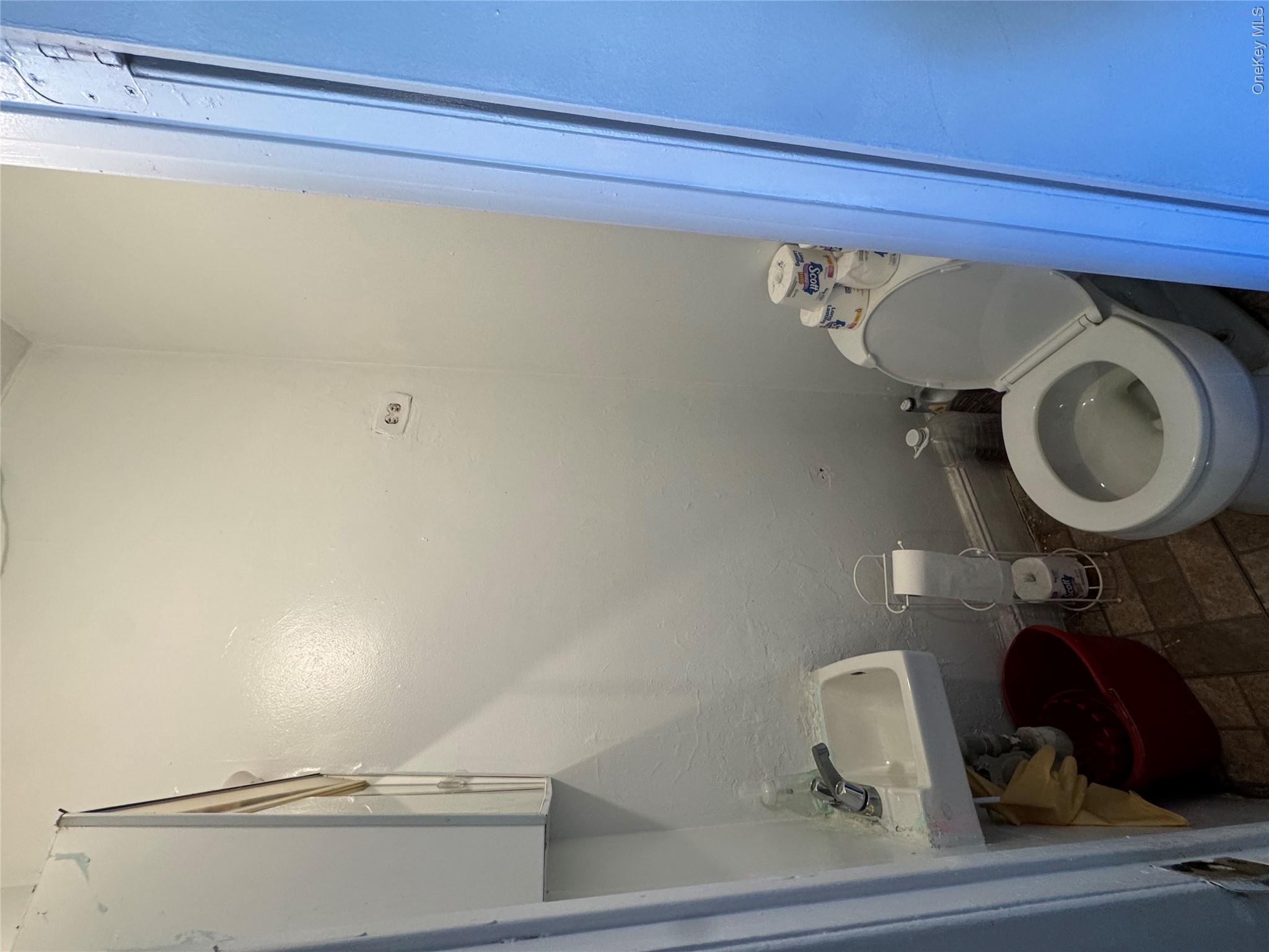 41-31 Hampton Street Queens, NY 11373 - Photo 11 of 23 a white toilet sitting next to a bathroom sink