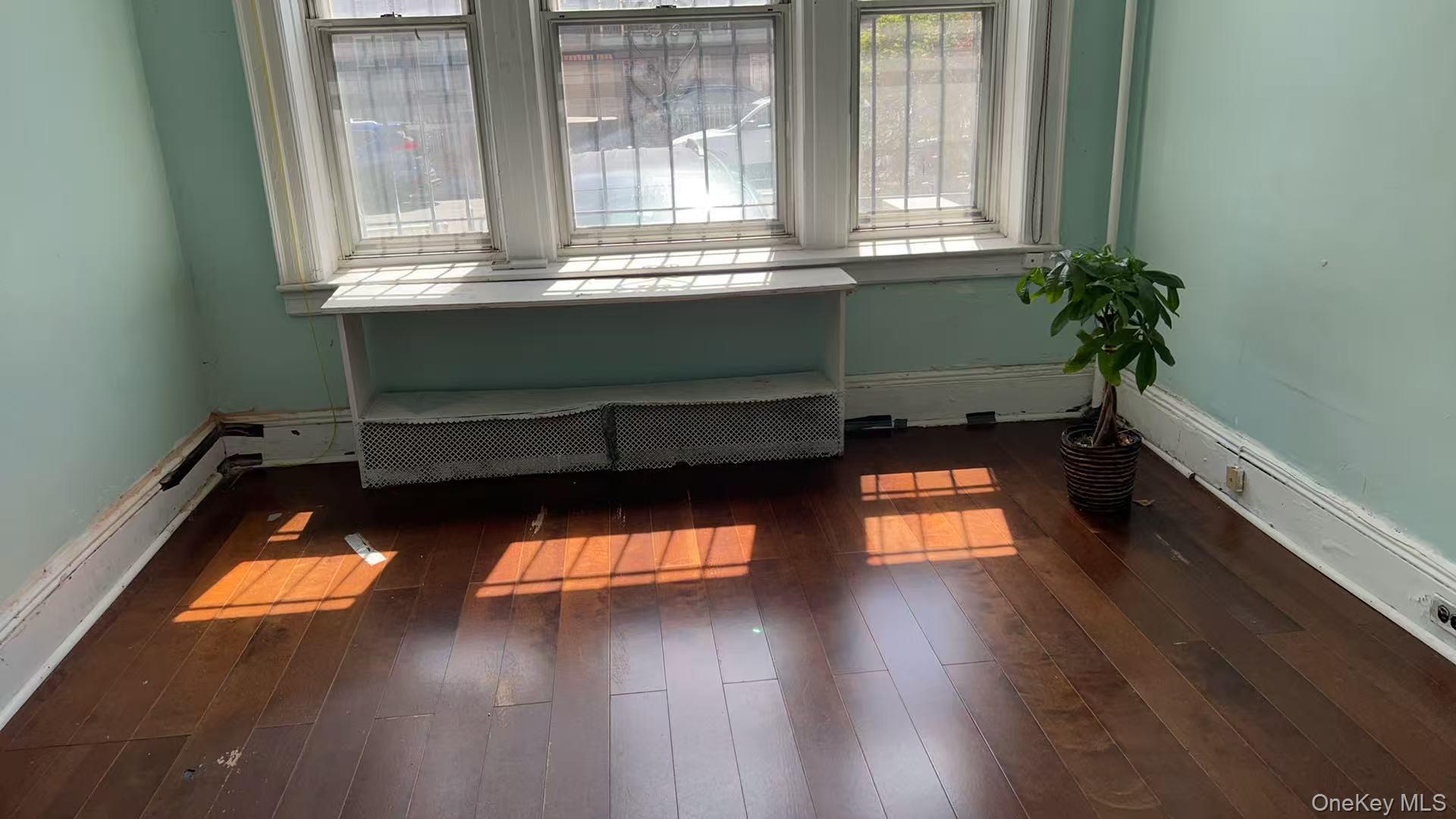 41-31 Hampton Street Queens, NY 11373 - Photo 12 of 23 a room with window and wooden floor