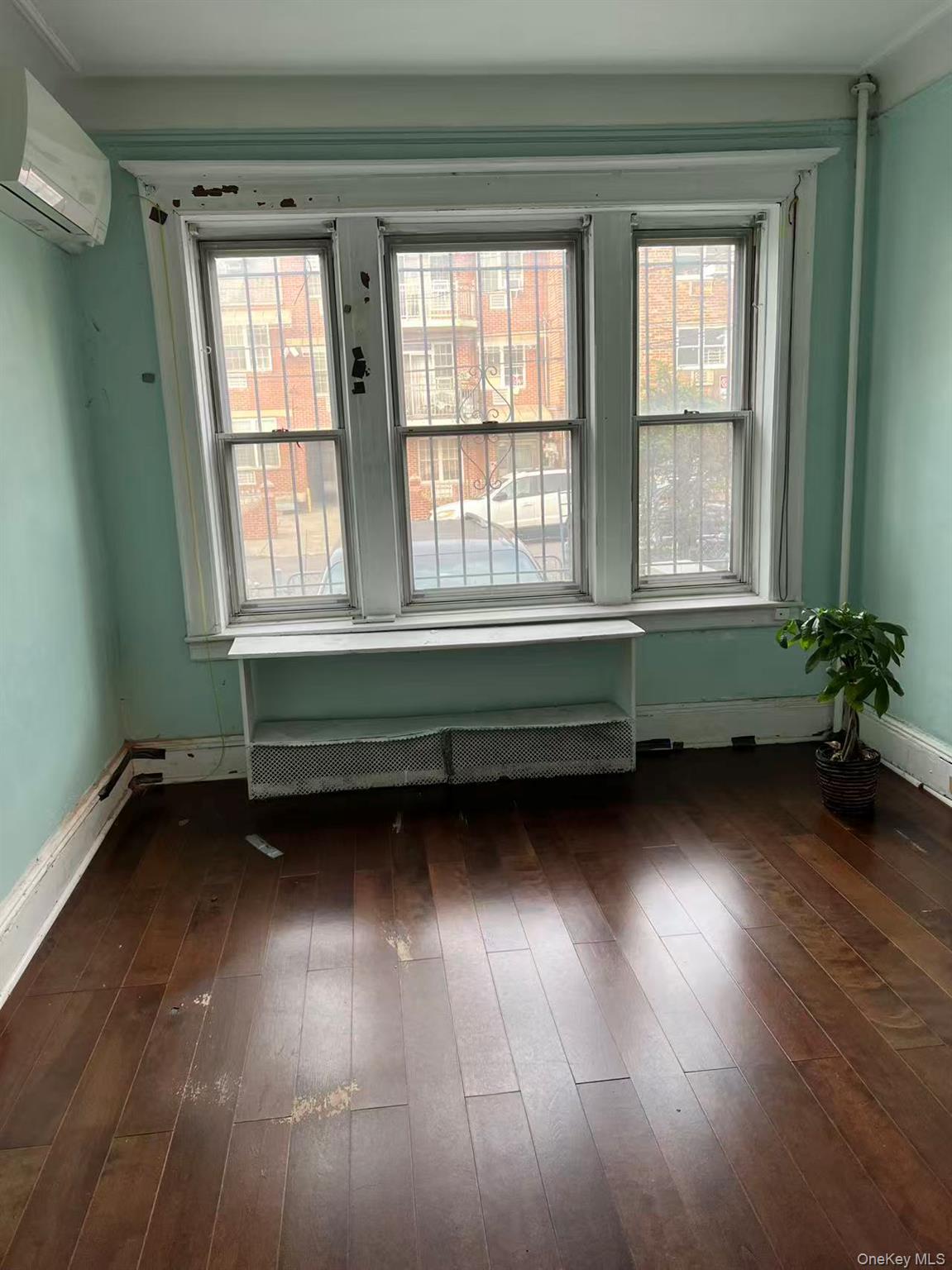 41-31 Hampton Street Queens, NY 11373 - Photo 13 of 23 a room with window and wooden floor