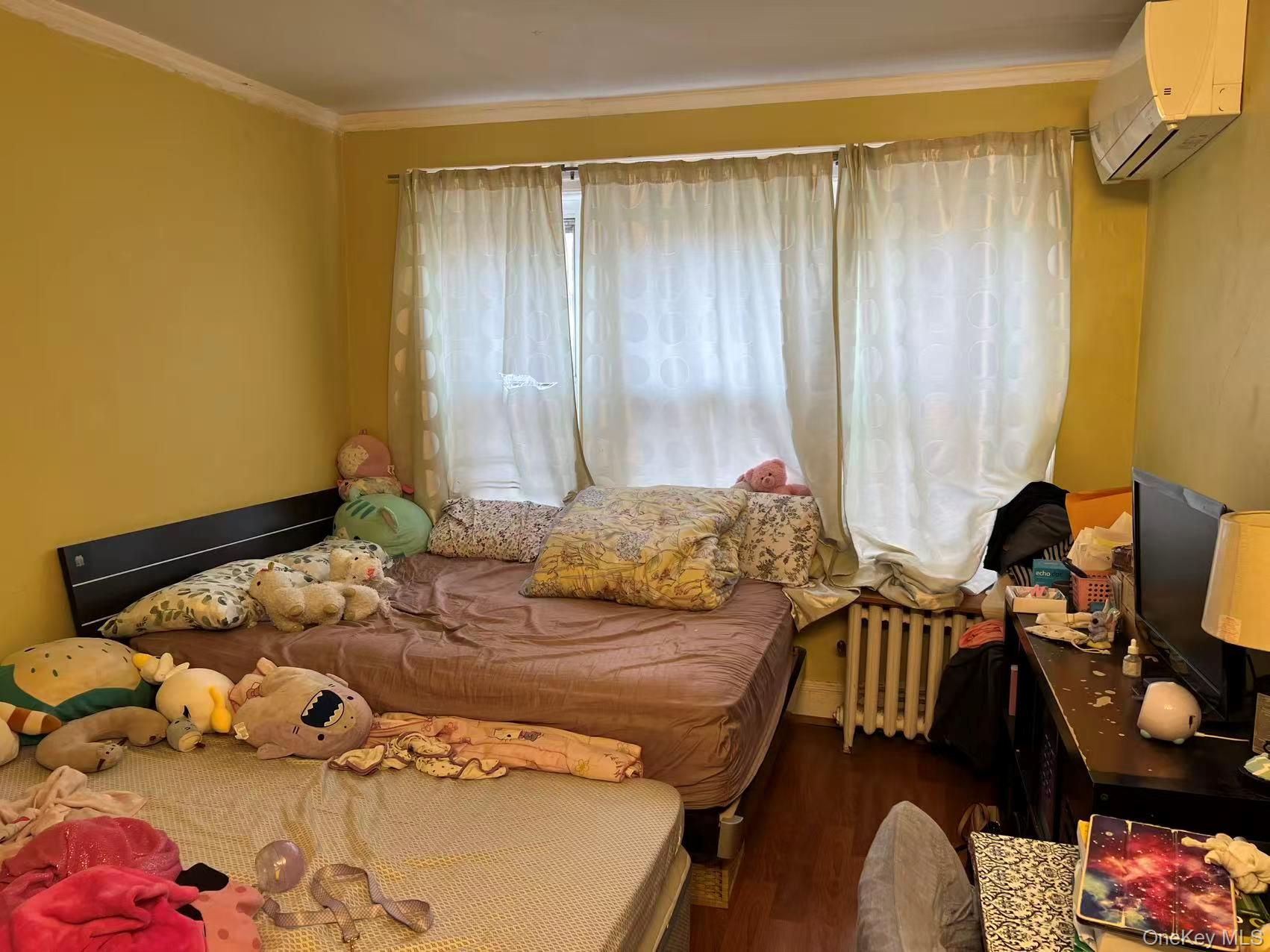 41-31 Hampton Street Queens, NY 11373 - Photo 17 of 23 a bedroom with a bed and wooden floor