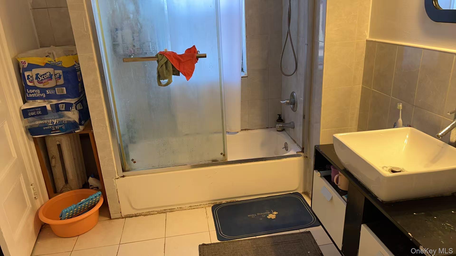 41-31 Hampton Street Queens, NY 11373 - Photo 22 of 23 a bathroom with a tub and shower