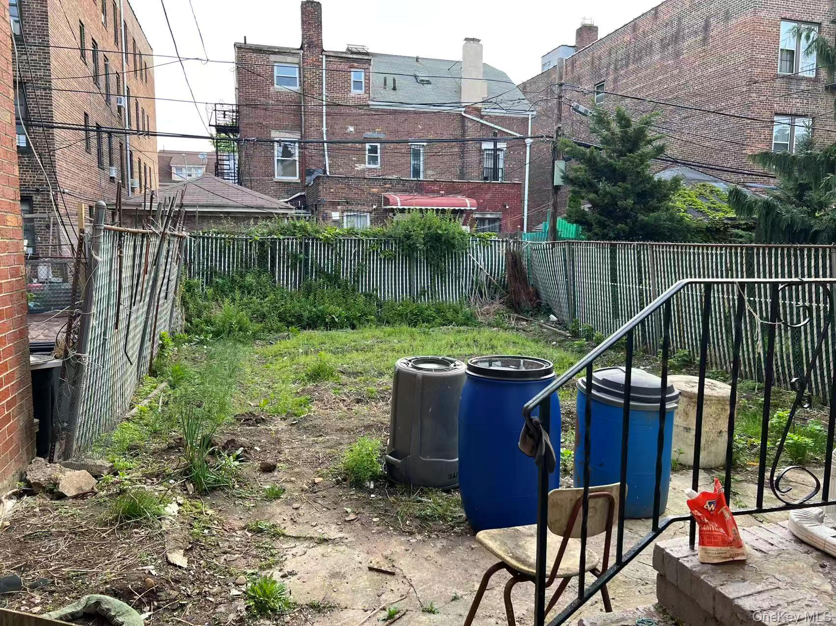41-31 Hampton Street Queens, NY 11373 - Photo 23 of 23 a view of a chairs and table in the backyard