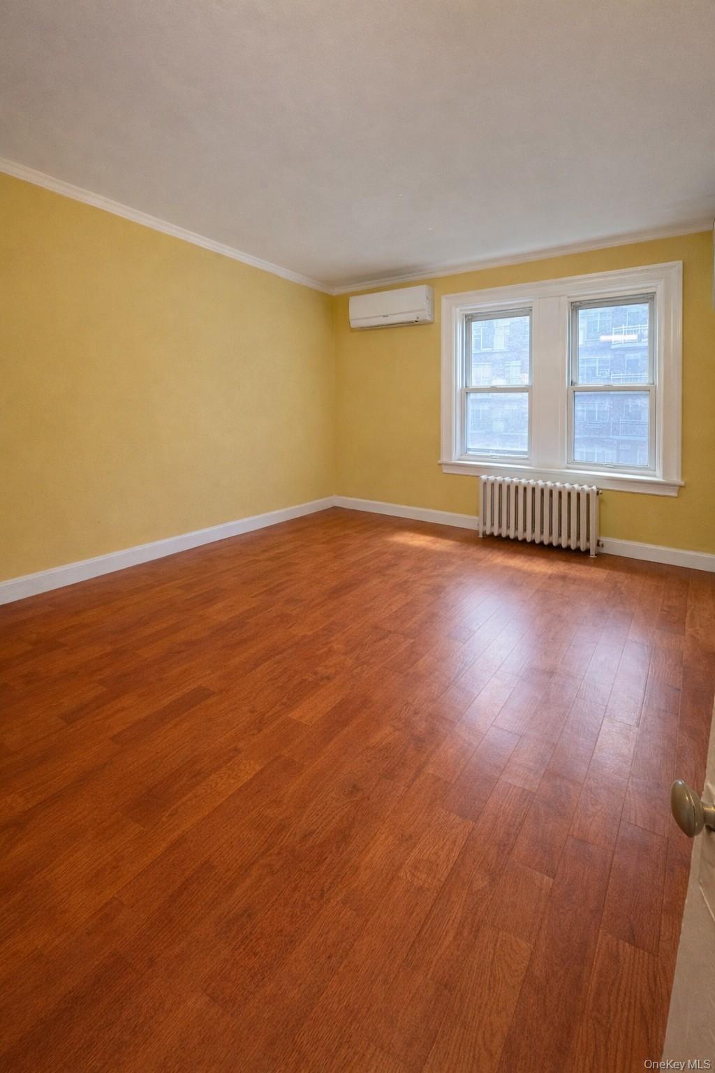 41-31 Hampton Street Queens, NY 11373 - Photo 3 of 23 a view of an empty room with wooden floor and a window