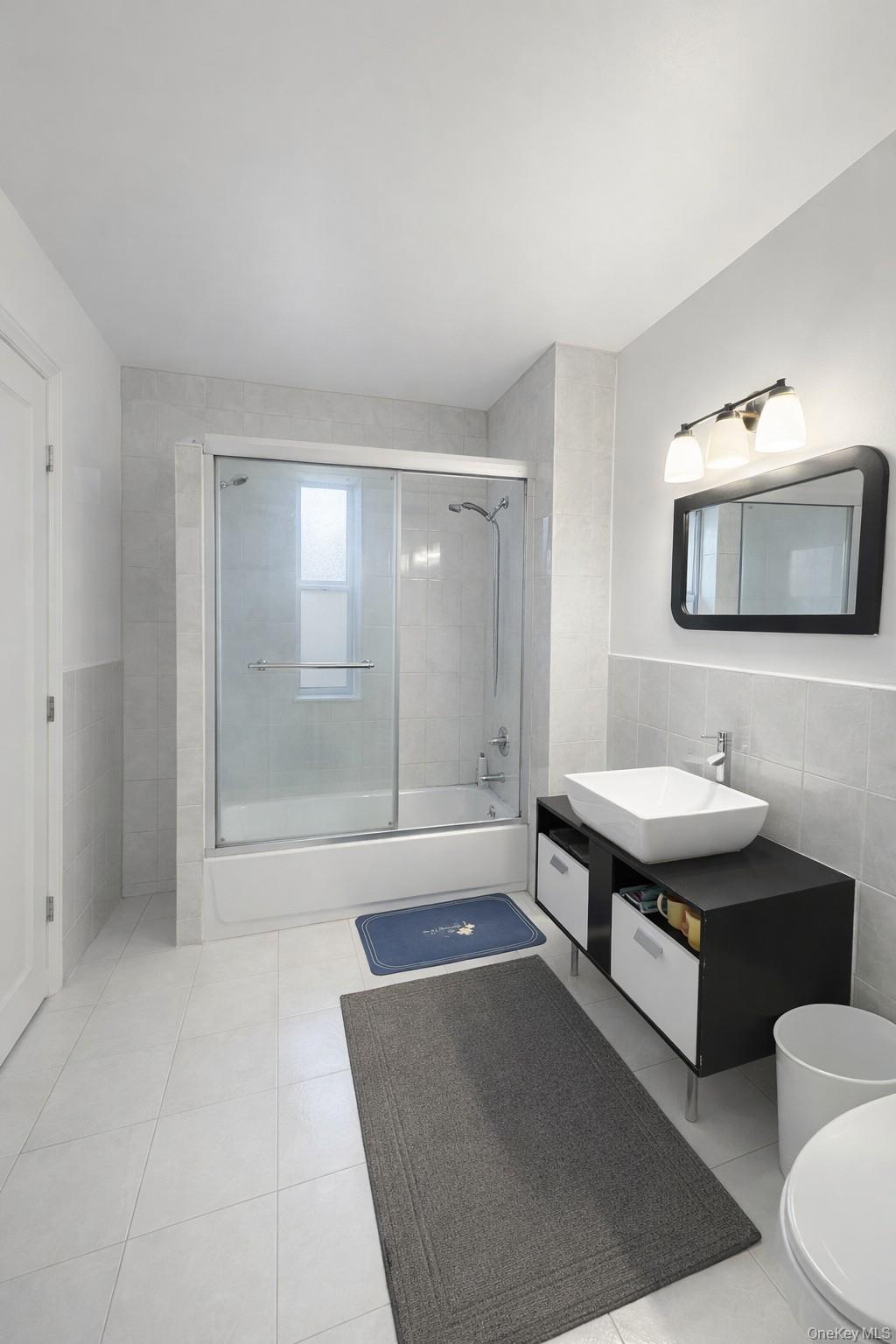 41-31 Hampton Street Queens, NY 11373 - Photo 7 of 23 a bathroom with a sink a toilet a mirror and shower