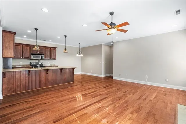 a kitchen with kitchen island a counter top space a sink and cabinets