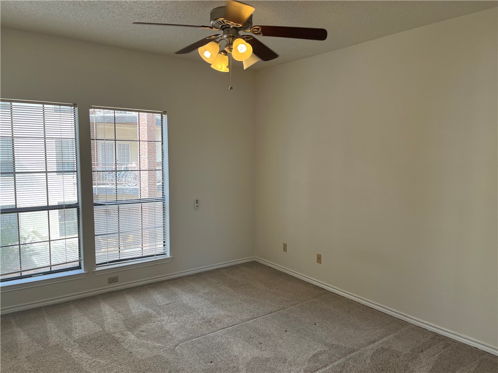 3001 Cedar Street, Unit A214 Austin, TX 78705 - Photo 9 of 17 an empty room with windows and fan