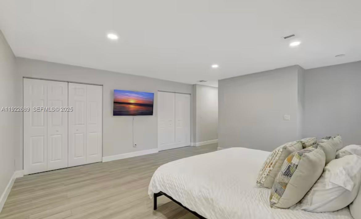 2080 Northeast 205th Street Miami, FL 33179 - Photo 11 of 24 a bedroom with a bed and a flat screen tv