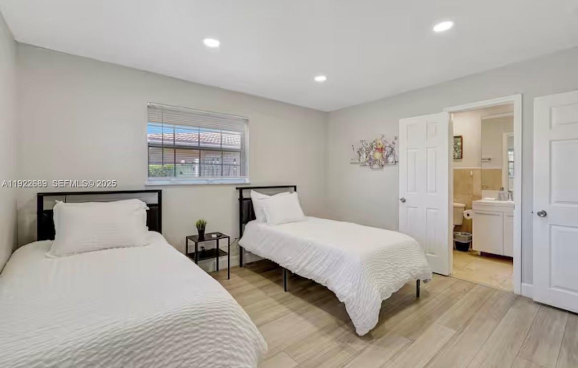 2080 Northeast 205th Street Miami, FL 33179 - Photo 12 of 24 a bedroom with a large bed and a table